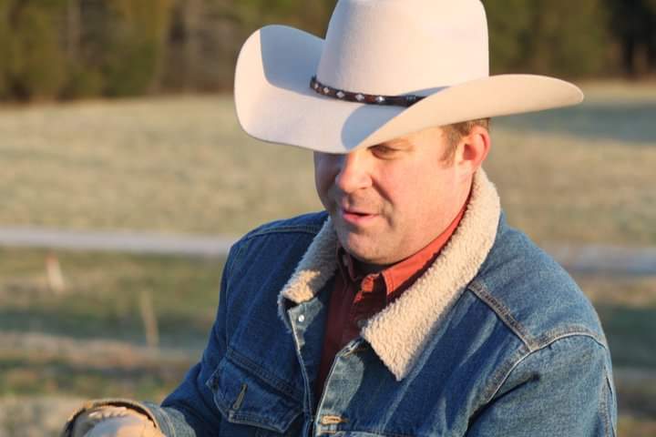 A ranch leader in a cowboy hat